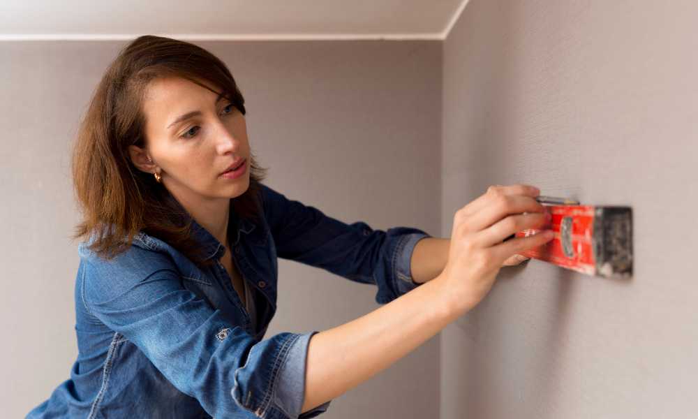 marking a spot on a wall to hang sconces 