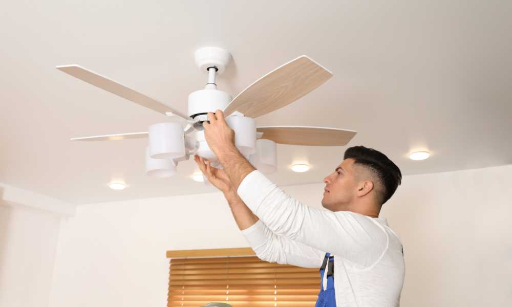 Man Replacing a Ceiling Fan Light