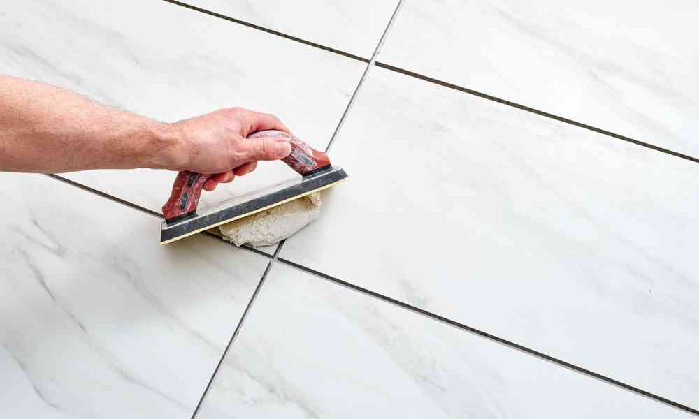 Grout floor tiles after installing them.