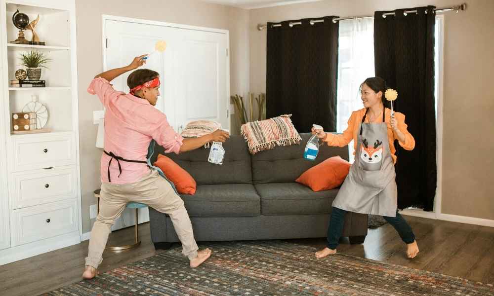 two people cleaning couch with vinegar