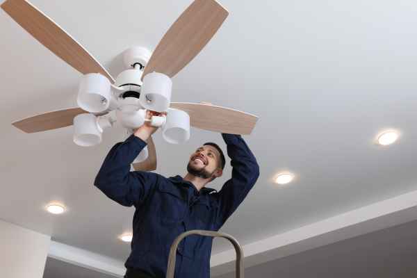 man cleaning a ceiling fan 